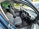 Car interior with gray seats and dashboard, showing steering wheel and dashboard controls.