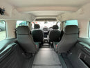 Interior of Peugeot Partner WAV showing wheelchair bay with gray seats and visible dashboard