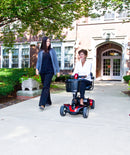 Go-Go Elite Traveller Sport being driven on a day out to a stately home. An older lady drives the scooter and is accompanied by a younger female companion