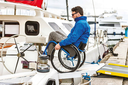 A wheelchair user using a Progeo Joker active wheelchair pops a wheelie down the gang plank as he manoeuvres onto a sailing boat