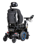 Q300M Mini Powerchair. Image shows Q300M Mini with Blue accents and blue patterned shrouds rear 3/4 view