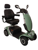 A green and black electric mobility scooter with a high-back black seat, rearview mirrors, and rugged tires, shown on a plain white background.