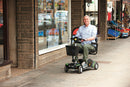 Man riding his Vierra LiFe Lithium Travel Scooter in town