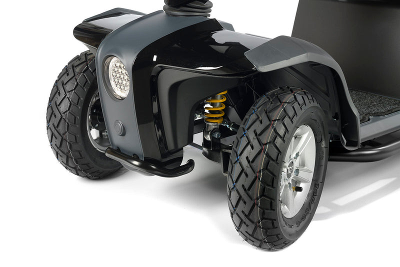 Close-up of Vita E mobility scooter headlights and suspension with large wheels on a white background